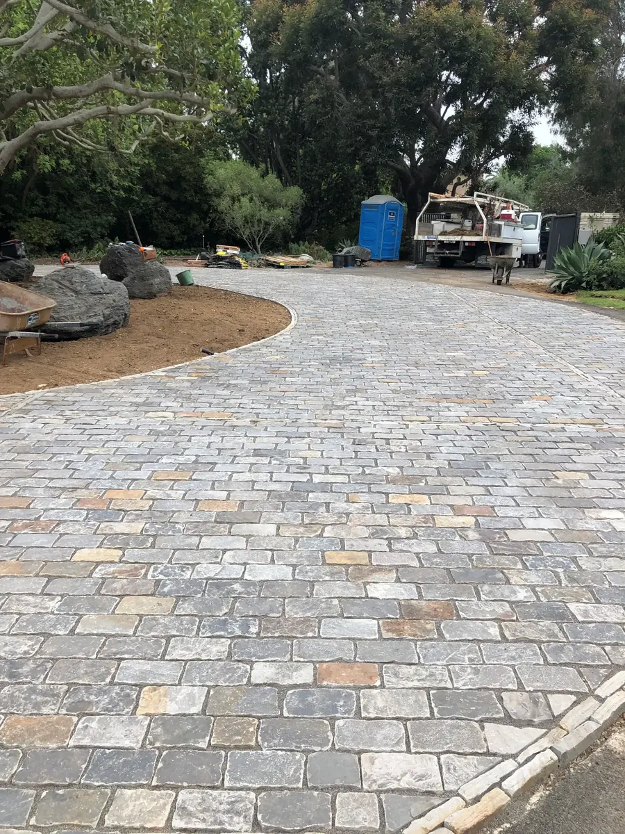 Natural stone driveway pavers mid-installation at the Hartley estate
